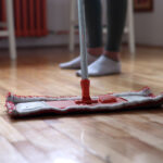 Woman using mop cleaner to maintain hardwood floors